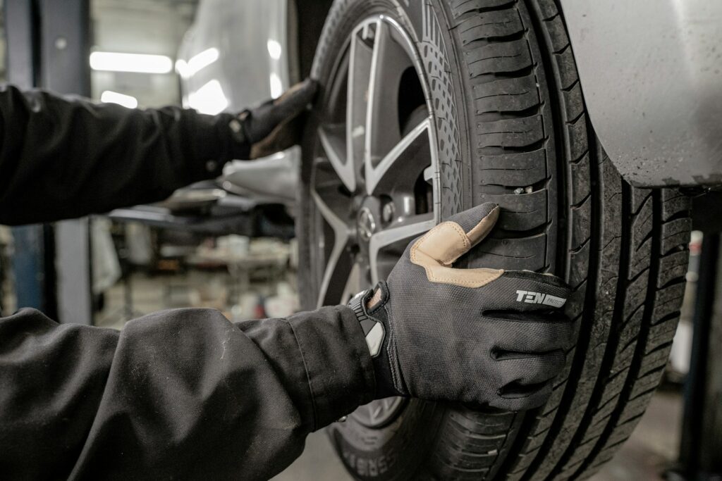 a man working on a tire in a garage